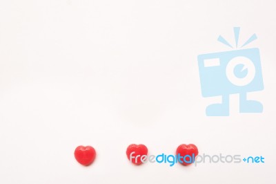 Three Red Valentine's Day Heart Shape Candy Line On White Paper Background. Love Concept. Minimalism Style. Knolling Top View Stock Photo