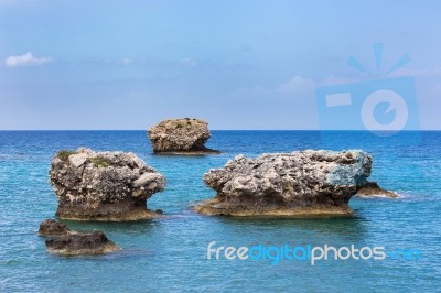 Three Separate Rocks Offshore In Sea Stock Photo