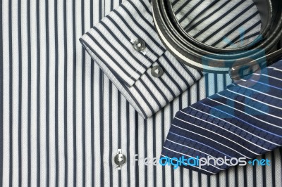 Tie And Belt On Striped Shirt Background Stock Photo