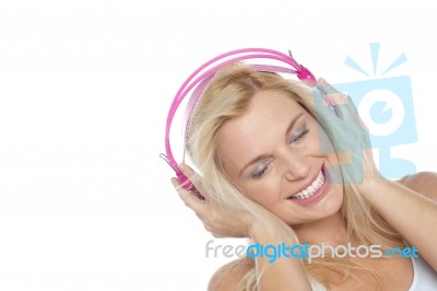 Tilted Shot Of A Blonde Engrossed In Music Stock Photo