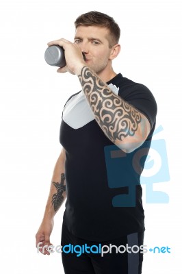 Tired Young Gym Instructor Drinking Water Stock Photo