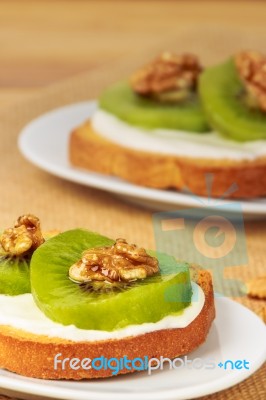 Toast With Kiwi, Cheese And Walnuts Stock Photo