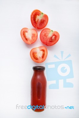 Tomatoes Juice In Bottle And Fresh Tomatoes Slices On White Wood… Stock Photo