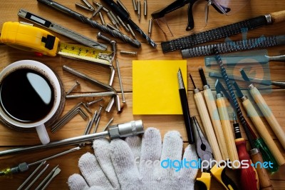 Tools Equipment With Coffee And Notepad On Wood Stock Photo