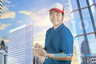 Toothy Smiling Face Of Delivery Man And Smart Computer In Hand Preparing For Taking Customer Order Isolated Whtie Background Stock Photo