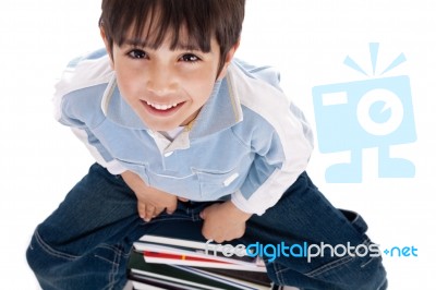 Top Angle Image Of Kid Sitting On Books Stock Photo Top Angle Image Of Kid Sitting On Books Stock Photo