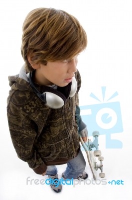 Top View Of Child With Skateboard And Headphone Stock Photo