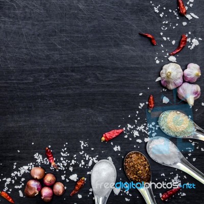 Top View Of Food Ingredients And Condiment On The Table, Ingredients And Seasoning On Dark Wooden Floor Stock Photo