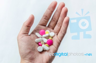 Top View Of The Pills On The Hand And White Background, A Hand Hold The Pills And Drug Stock Photo