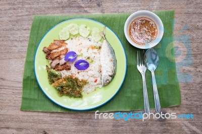 Top View Thai Traditional Spicy Fried Rice With Chili Paste,fried  Mackerel,crispy Pork  And Local Vegetable On Banana Leaf Stock Photo