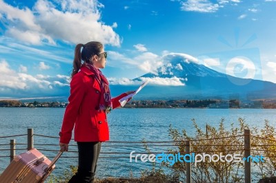 Tourist With Baggage And Map At Fuji Mountain, Kawaguchiko In Japan Stock Photo