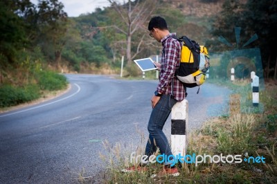 Tourists Man Look At A Map On The Tablet On Mountain Roads Stock Photo