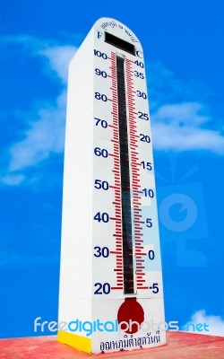 Tower Of Thermometer Isolated On Blue Sky Background Stock Photo