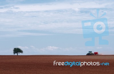 Tractor Plowing On Field Stock Photo