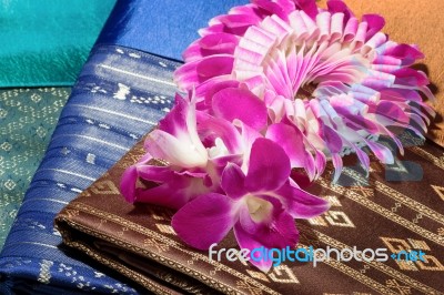 Traditional Brown Thai Fabric Pattern With Orchid Garland Stock Photo