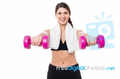 Trainer Holding Dumbbells In Her Outstretched Arms Stock Photo