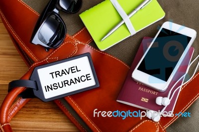 Travel Insurance Tag With Tourist Accessories Stock Photo