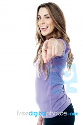 Trendy Girl Pointing Towards You Stock Photo