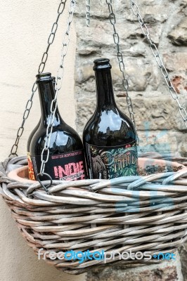 Two Beer Bottles In An Hanging Basket In Citta Alta Bergamo Stock Photo