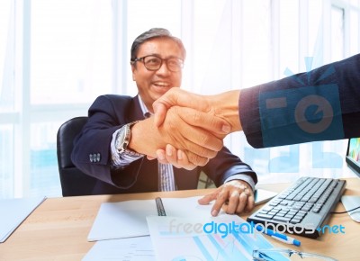 Two Business Man Shaking Hand With Happiness Emotion After Agreement In Working Solution ,shot On Office Working Table Stock Photo