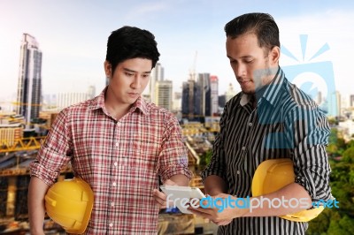 Two Engineer Discussing Project Stock Photo