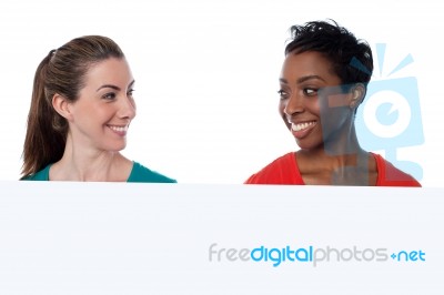 Two Female Friends Facing Each Other Stock Photo