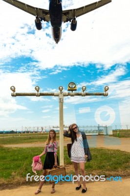 Two Girls Hitchhiking A Plane Stock Photo