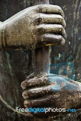 Two Metal Hands Gripping A Metal Rod Tightly Stock Photo