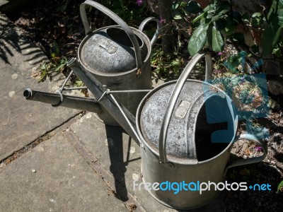 Two Old Watering Cans Stock Photo
