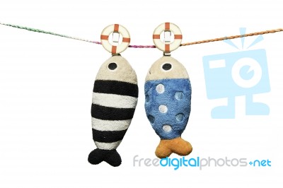 Two Pillows Fish Shape Hanging On The Rope Isolated On White Background Stock Photo