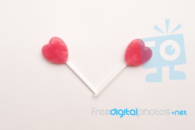 Two Pink Valentine's Day Heart Shape Lollipop Candy On Empty White Paper Background. Love Concept. Knolling Top View. Minimalism Colorful Hipster Style Stock Photo