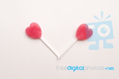 Two Pink Valentine's Day Heart Shape Lollipop Candy On Empty White Paper Background. Love Concept. Knolling Top View. Minimalism Colorful Hipster Style Stock Photo