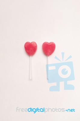 Two Pink Valentine's Day Heart Shape Lollipop Candy On Empty White Paper Background. Love Concept. Knolling Top View. Minimalism Colorful Hipster Style Stock Photo