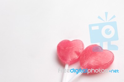 Two Pink Valentine's Day Heart Shape Lollipop Candy On Empty White Paper Background. Love Concept. Minimalism Colorful Hipster Style Stock Photo