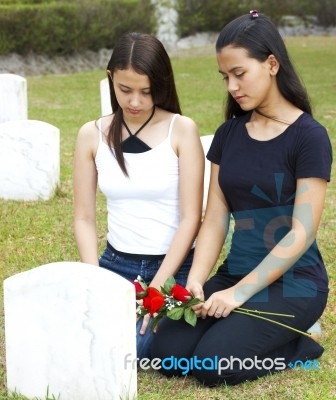 Two Sad Girls At A Grave Stock Photo