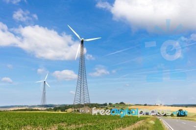 Two Windmills In Rural Area With Blue Sky Stock Photo