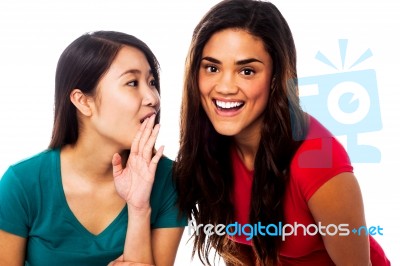 Two Young Girls Gossiping Stock Photo