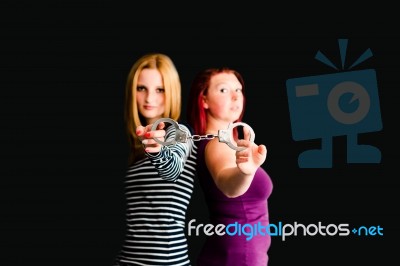 Two Young Women With Handcuffs Stock Photo