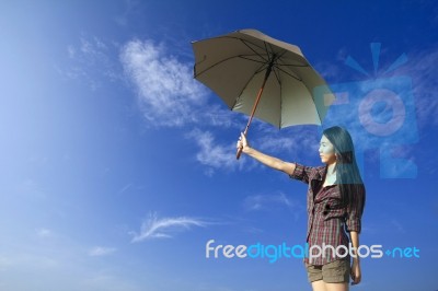 Umbrella And Woman In Blue Sky Stock Photo