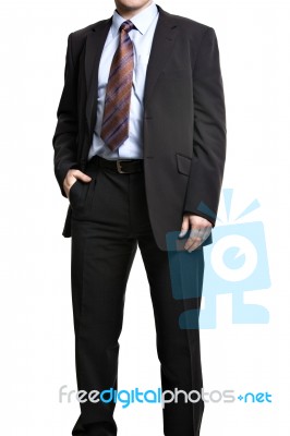 Unrecognizable Businessman In Suit Standing With Hand In Pocket Stock Photo