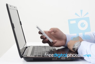 Using Smart Phone And Laptop Stock Photo