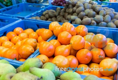 Various Fruit In Blue Crates On Market Stock Photo