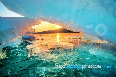 Very Large And Beautiful Chunk Of Ice At Sunrise In Winter Stock Photo
