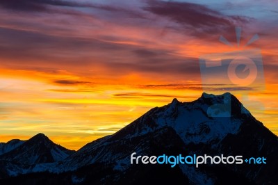 Vibrant Sunset Behind Mountian Stock Photo