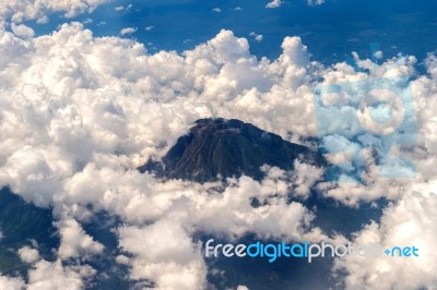 View From Airplane Window To Volcano Mountain Stock Photo