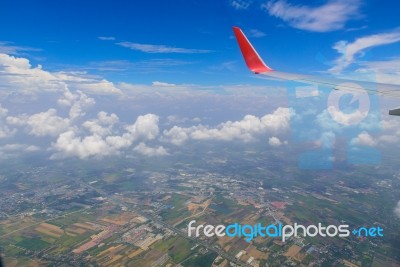 View From Airplane Window. Wing Of An Airplane Flying Above The Stock Photo
