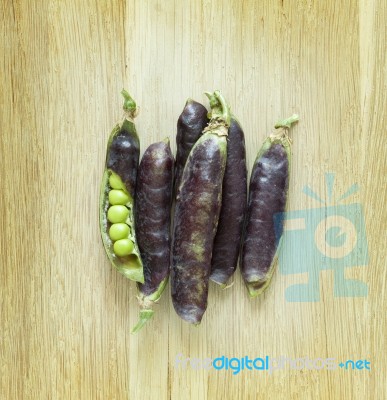 View Of Fresh Violet Pea Pods And Peas Stock Photo