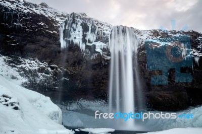 View Of Seljalandfoss Waterfall In Winter Stock Photo