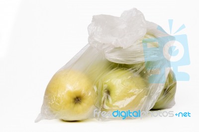 View Of Some Yellow Apples Inside A Plastic Bag Stock Photo