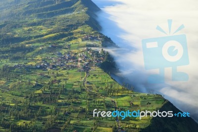 Village And Cliff At Bromo Volcano Mountain Stock Photo